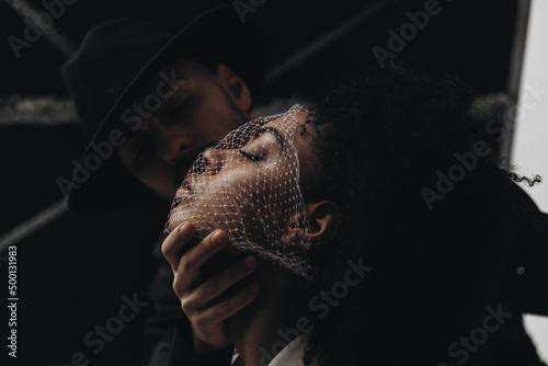 Creative photo. Man and young african american woman with curly hair with mesh on face. smelling concept. love concept. perfumes smelling concept. aroma