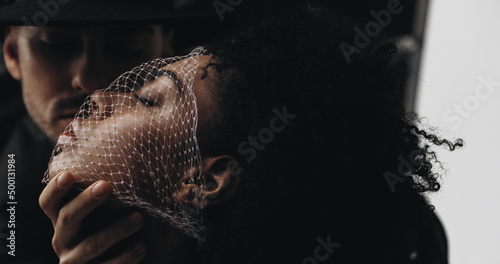 Creative photo. Man and young african american woman with curly hair with mesh on face. smelling concept. love concept. perfumes smelling concept. aroma
