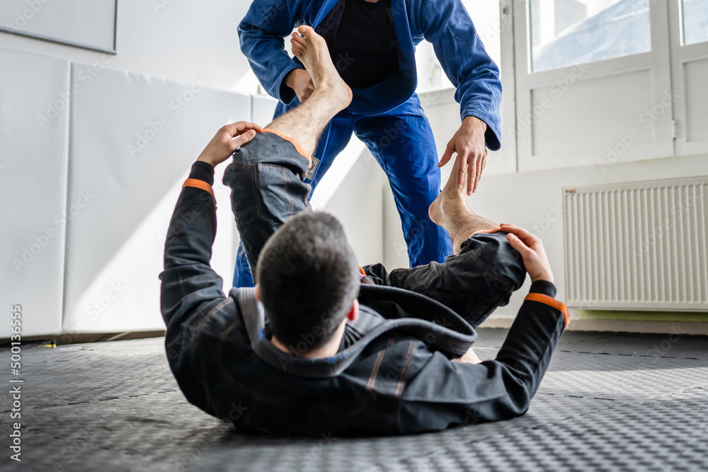 Two brazilian jiu jitsu BJJ athletes training at the academy martial