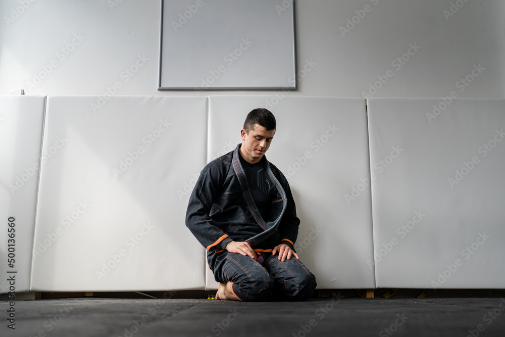 Brazilian jiu jitsu class at the academy male athlete preparing for