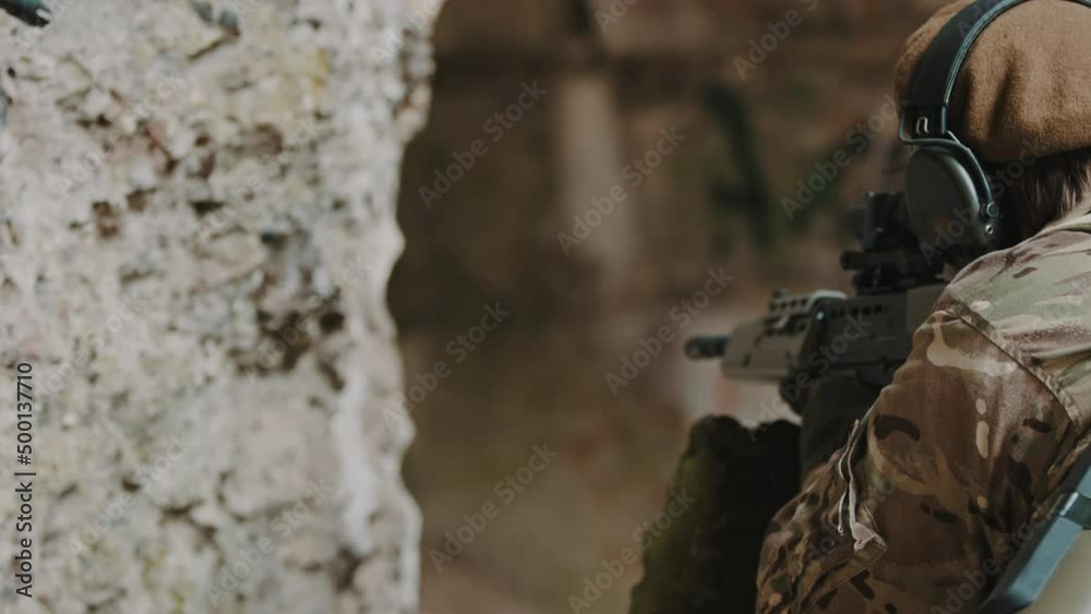 Sturdy firm grip holding a automatic rifle gun as a rookie female soldier . High quality 4k footage Sturdy firm grip holding a automatic rifle gun as a rookie female soldier . High quality 4k footage