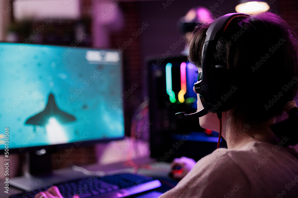 Happy woman streaming online multiplayer video games play on computer, enjoying shooting gameplay tournament. Female streamer playing action rpg game competition on pc monitor. Happy woman streaming online multiplayer video games play on computer, enjoying shooting gameplay tournament. Female streamer playing action rpg game competition on pc monitor.