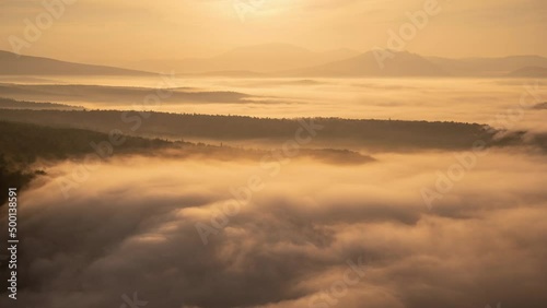 Stunning time lapse of drifting clouds during warm morning light on a sunrise over mountains. Nature of South Urals, Bashkortostan, Russia photo
