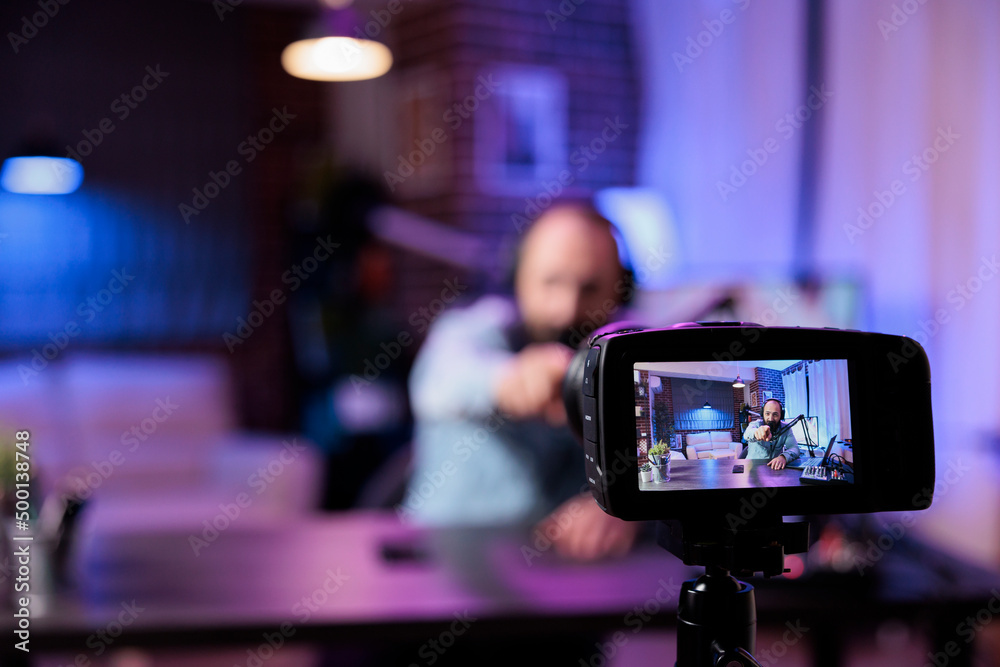 Content creator using camera to record podcast show in filming studio with modern equipment. Online influencer recording live video discussion to have fun on internet channel. Livestream. Content creator using camera to record podcast show in filming studio with modern equipment. Online influencer recording live video discussion to have fun on internet channel. Livestream.