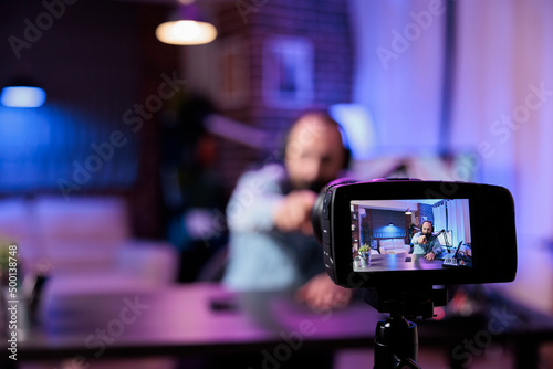 Content creator using camera to record podcast show in filming studio with modern equipment. Online influencer recording live video discussion to have fun on internet channel. Livestream.