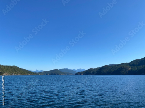 Entrance to Jervis Inlet with Coast Mountains and temperate rainforest on the Sunshine Coast with blue skies, British Columbia, Canada