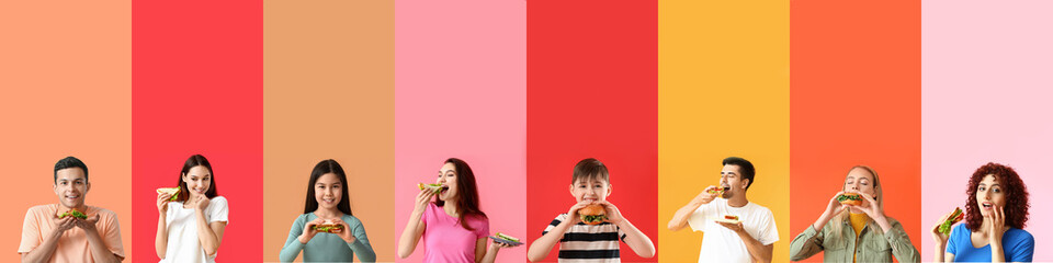 Group of people eating tasty sandwiches on color background with space for text