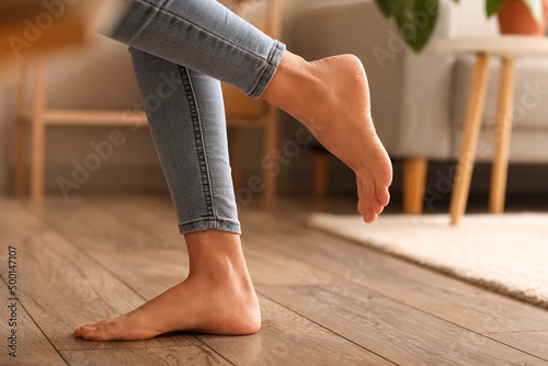 Bare feet of young woman at home, closeup © Pixel-Shot