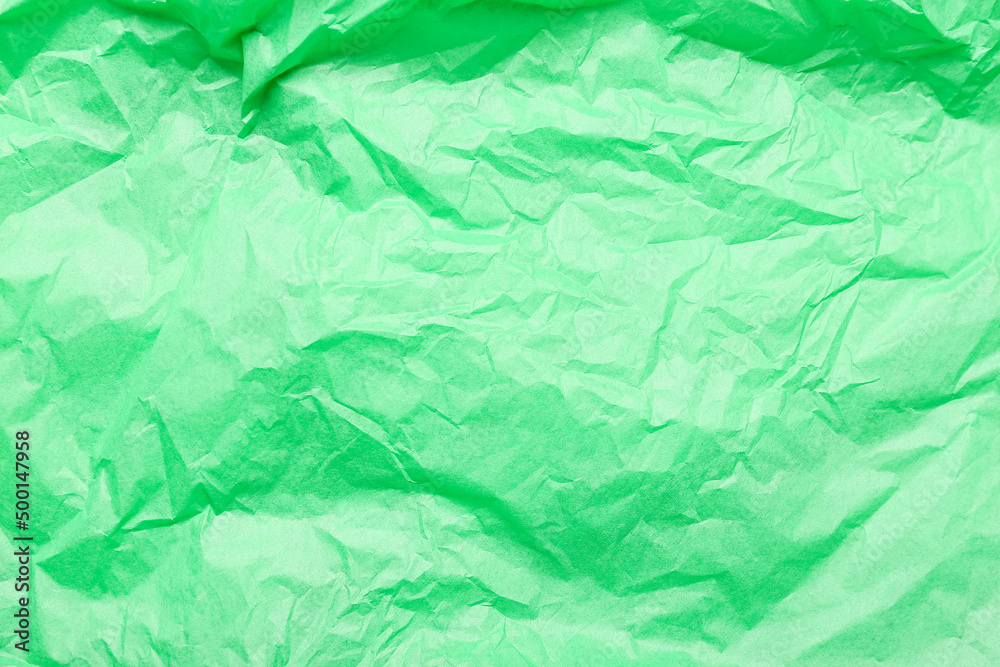 Obraz premium Texture of green crumpled paper as background, closeup