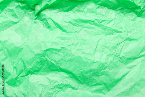 Texture of green crumpled paper as background, closeup