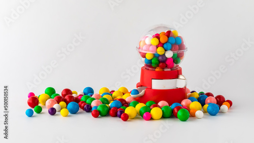Foto A plastic toy gum ball machine filled and surrounded by gum balls