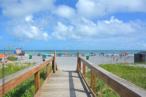 View of beach from wooden boardwalk over the dunes in Cocoa Beach  Florida near Cape Canaveral. 