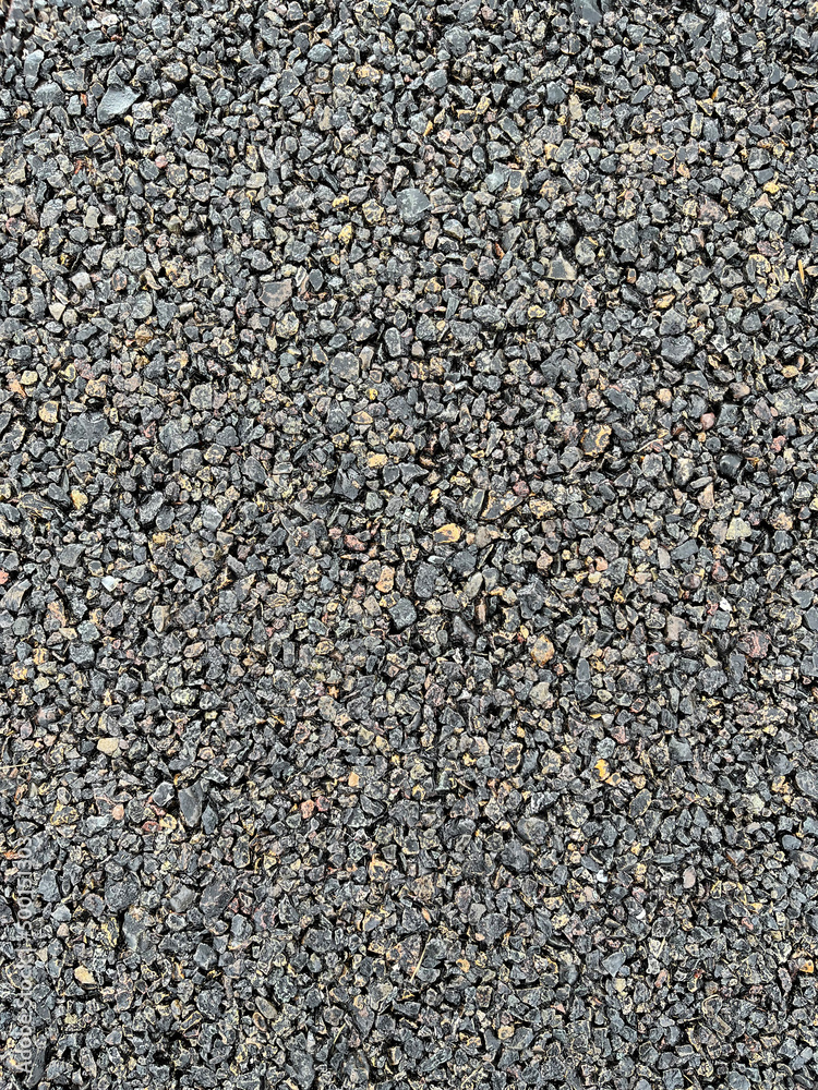 Obraz premium Dark grungy gravel packed into a pathway.