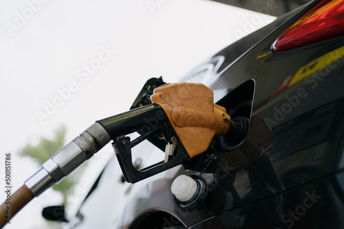 The car is filling up at the gas station