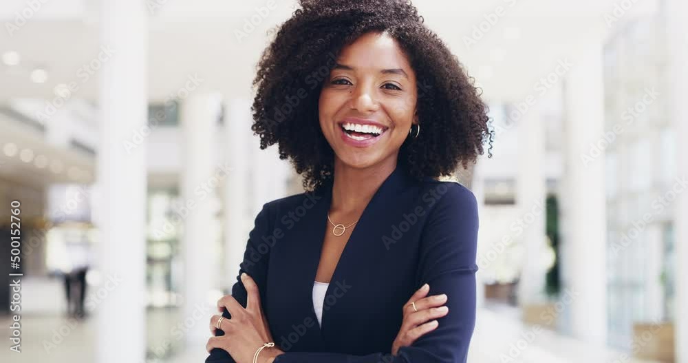 Let nothing overtake your determination to be your best. Beautiful confident happy young multi ethnic business woman standing alone with her arms crossed and smiling positively in a modern workspace