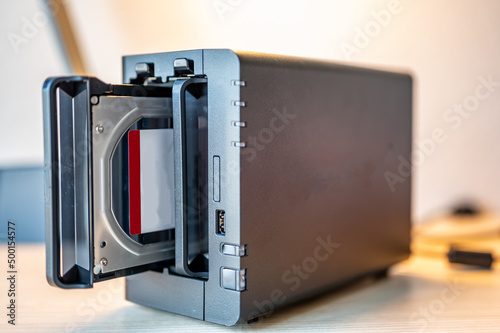 Fotografie network attached storage NAS with a single bay pulled setup at a home office and
