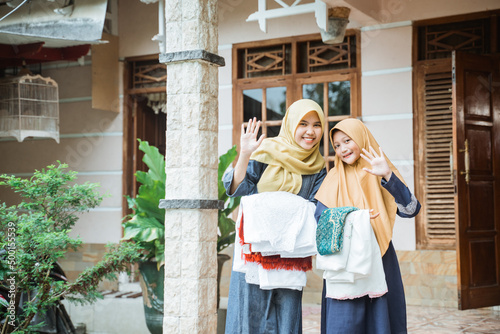 muslim mother and daughter getting ready to do idul fitri prayer together © Odua Images