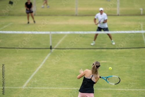 Amateur playing tennis at a tournament and match on grass in Melbourne, Australia 