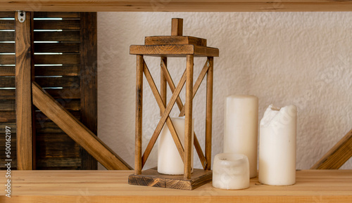 Obraz na plátně Old wooden decorative lamp and paraffin candles stand on shelf