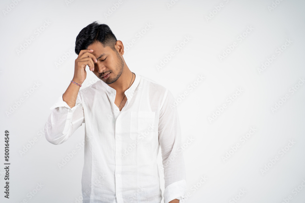 man with disappointed face with hands holding forehead while thinking on isolated background man with disappointed face with hands holding forehead while thinking on isolated background