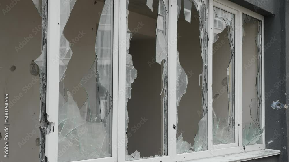 Aftermath shooting Ukraine shell civilian hitting building explosion glass. Shatter glass damage Ukraine war destruction building damage. Crash glass broken window house destroy building window crack