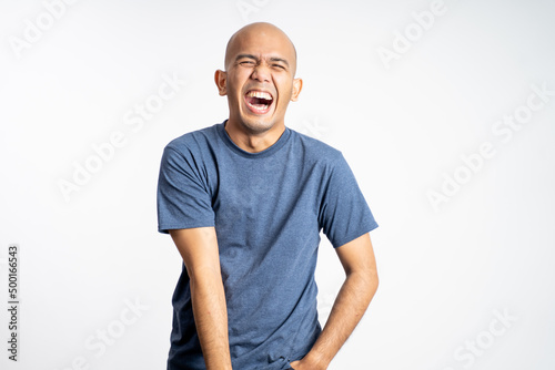 bald man laughing with mouth open while standing on isolated background