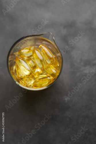 Capsules of omega-3 fatty acids on a gray background. The concept of medicine and a healthy lifestyle. Front view.
