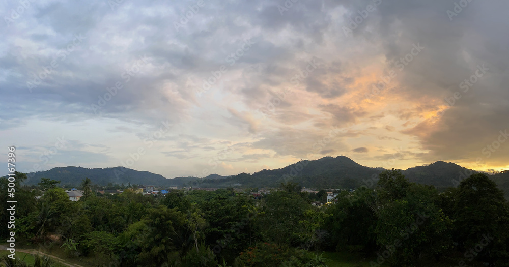 High resolution widescreen shot. Wide panorama, landscape. Beautiful sunset over mountains and valley. Full size horizontal illustration. Amazing sky with clouds. Summer twilight. Bright colours. View