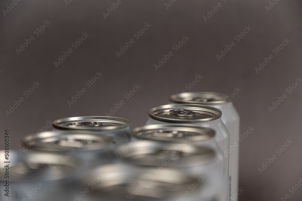 A defocused shot of a group of tin cans. New enclosed Metallic silver individual beverage containers. Selective focus. Noise, blur, grain effect A defocused shot of a group of tin cans. New enclosed Metallic silver individual beverage containers. Selective focus. Noise, blur, grain effect