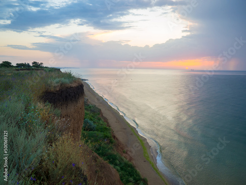 Thunderstorm at sea at dusk. The Beauty of Sunrise waves. Seascape with dramatic cloudy sky and rising sun in Ukraine. Sanzhiyka, Odesa. Landscape with sea and steep coast photo