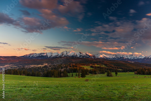 A beautiful sunset over the Tatra Mountains . The pass over Lapszanka in Poland
