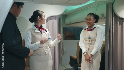 Air hostess is providing ticket checking service before boarding.