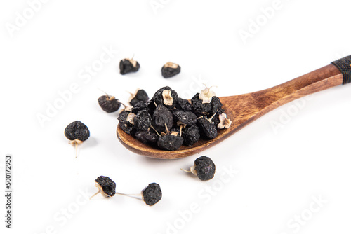 Tableau sur toile Black wolfberry in spoon isolated on white background