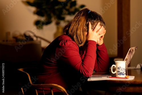 Young beautiful woman relaxing making making hot tea and coffee with a tea bag, in the kitchen of a home in melbourne, Australia. photo
