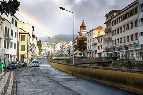 FUNCHAL, MADEIRA ISLAND - February 20, 2022: Funchal city street after the rain with a beautiful rainbow