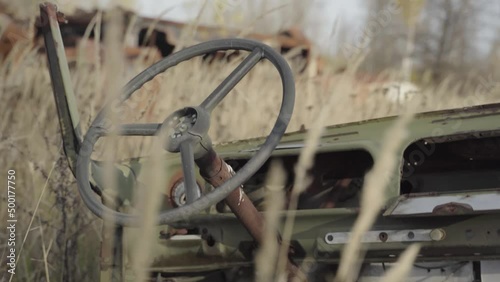 Abandoned rusty radioactive equipment of the soviet union. Cemetery of technology in Rassokha. Chernobyl. Ukraine photo