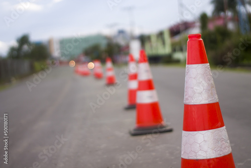 bright orange traffic cones standing in a row 