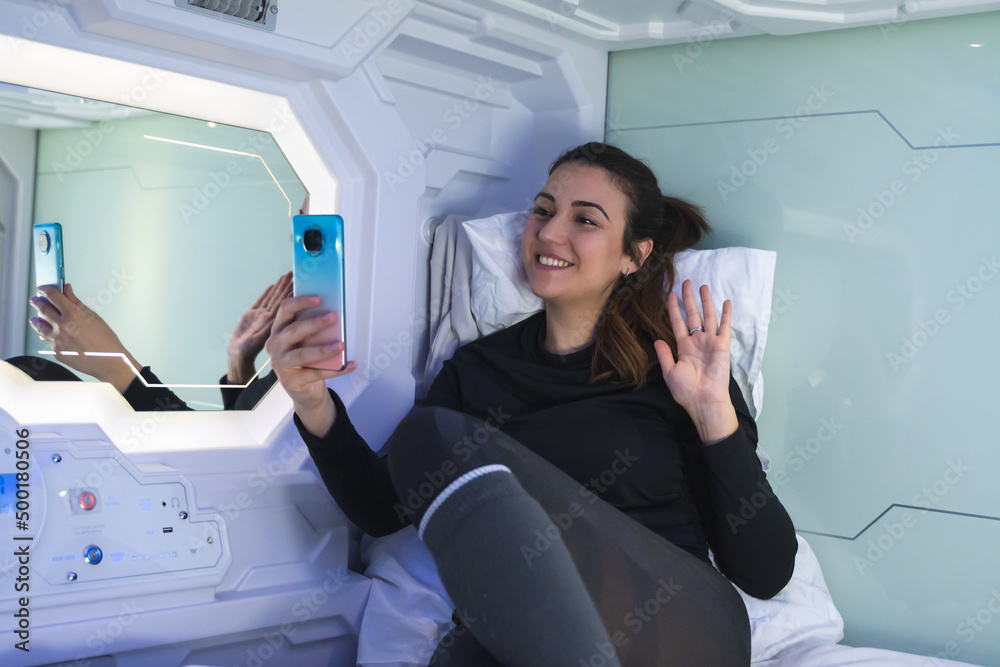 woman making video call saying good morning. She is Caucasian Spanish with white skin, eyes and dark hair.