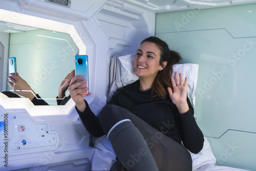 Obraz na płótnie woman making video call saying good morning. She is Caucasian Spanish with white skin, eyes and dark hair. w salonie