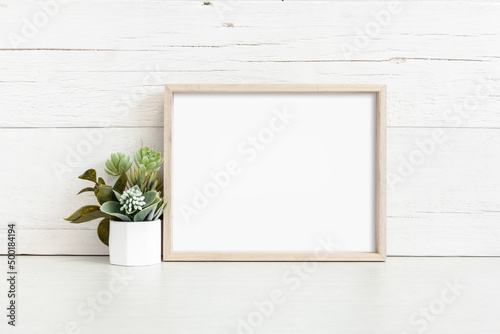 Mockup of a horizontal wooden frame on a light background © flipper1971