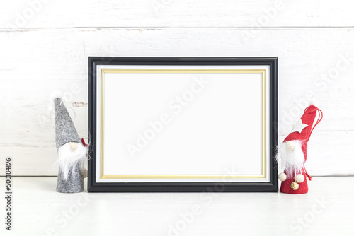 Black frame 10x15 on the table with holiday symbols. photo