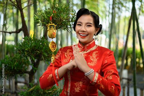Asian woman with Golden amulet for Chinese New Year lucky symbol decorations