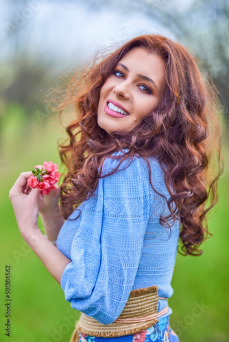 portrait of a beautiful brunette woman in spring nature.