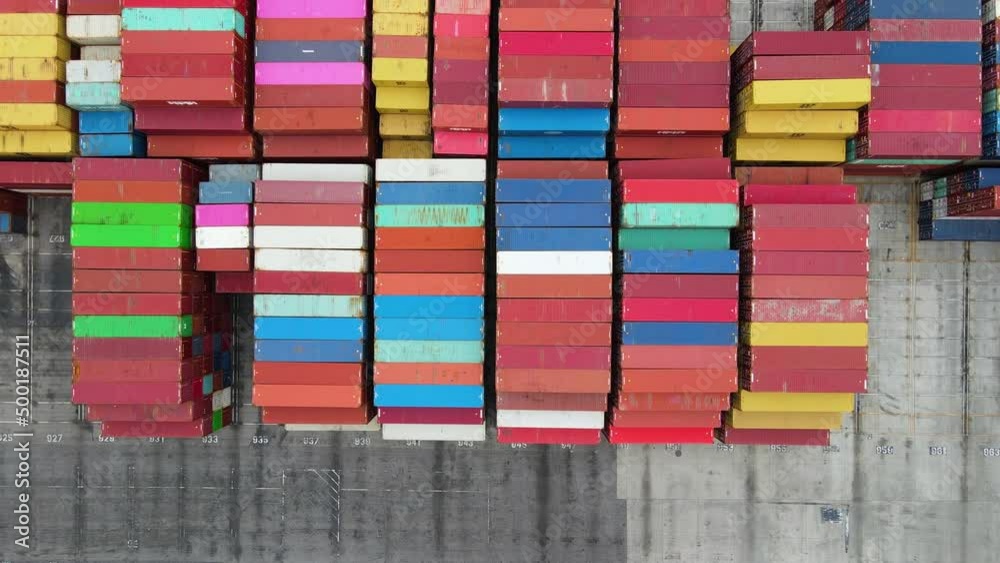 Aerial view above piles of colorful cargo crates at a dock - overhead, drone shot Aerial view above piles of colorful cargo crates at a dock - overhead, drone shot