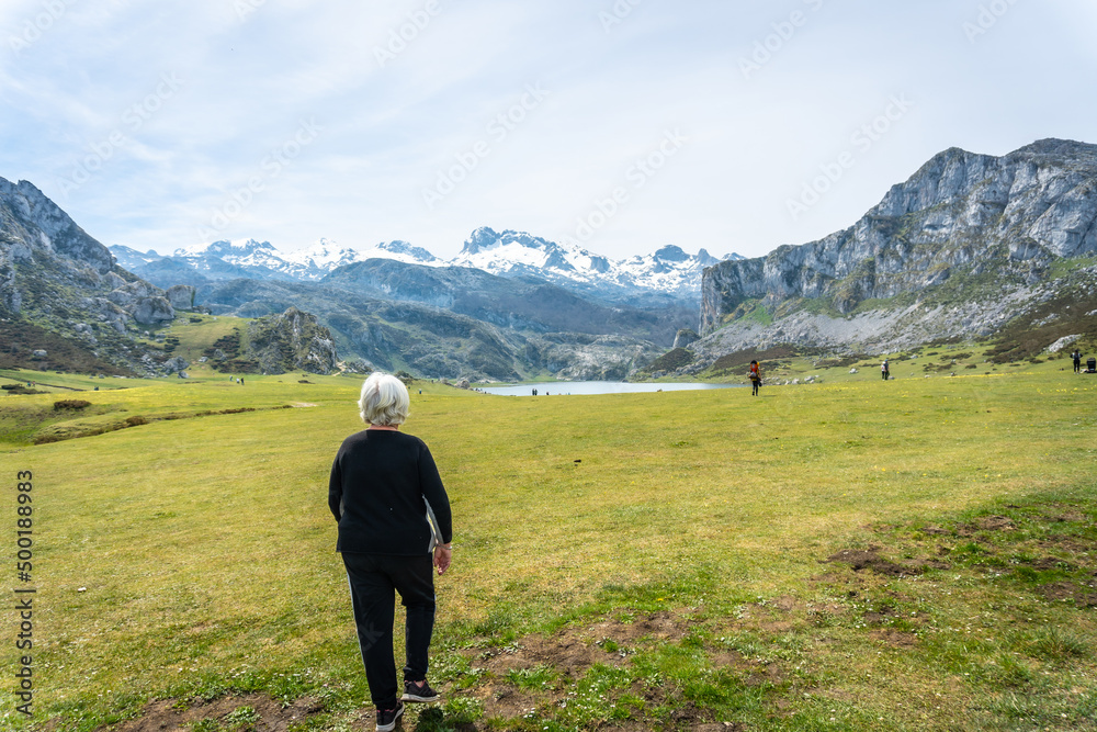 An elderly woman visiting Lake Ercina in the Lakes of Covadonga. Asturias. Spain