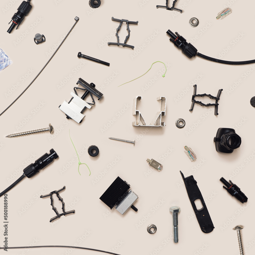 Obraz premium Various components for solar panels minimal concept. Pattern made of male female connectors, cable ties, tool kits, alu profile, mid and end clams, different screws and bolts. Flat lay gray background