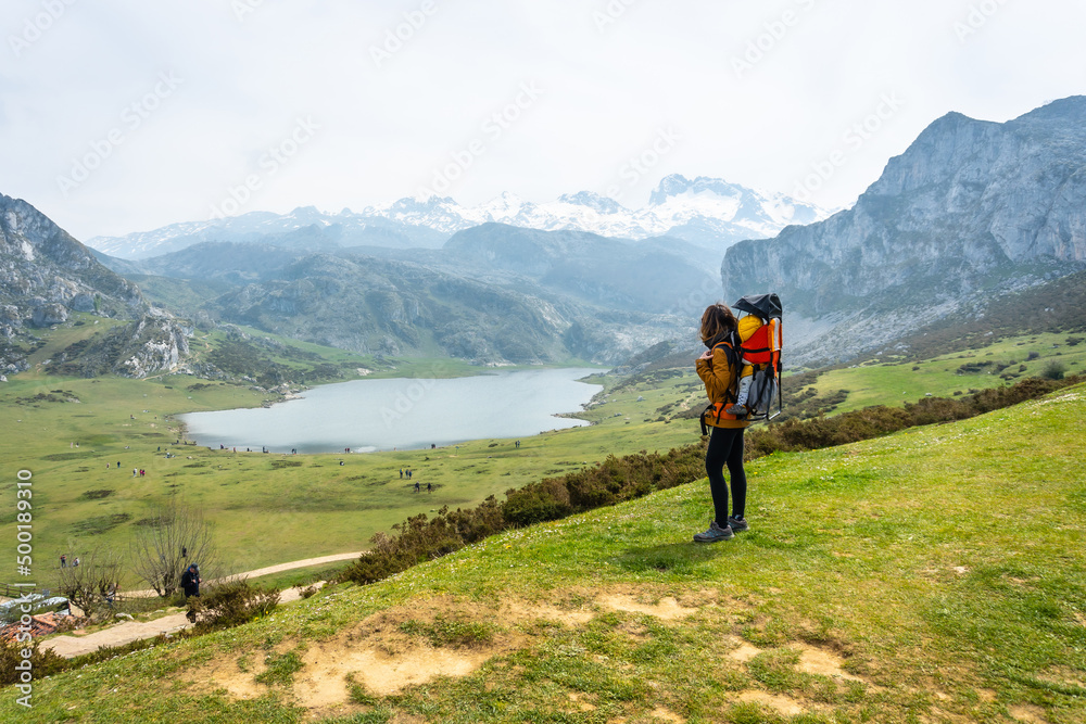 A mother with her baby at the entrelagos viewpoint and Lake Ercina in the background in the Lakes of Covadonga. Asturias. Spain