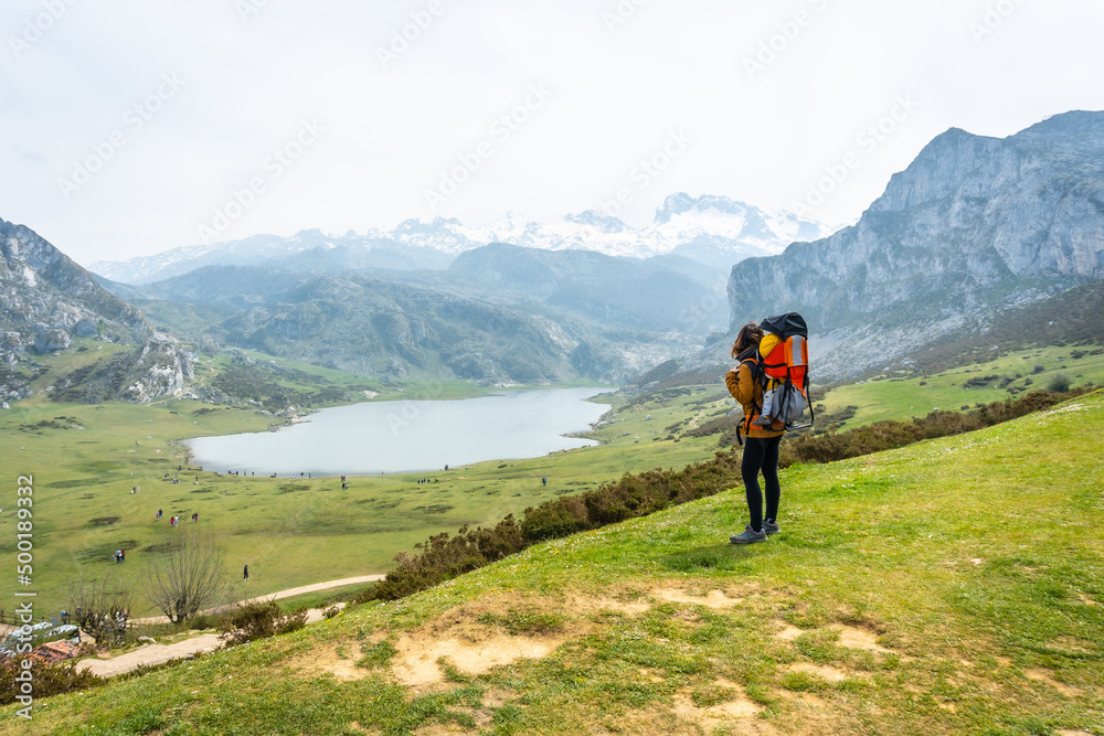 A mother with her baby at the entrelagos viewpoint and Lake Ercina in the background in the Lakes of Covadonga. Asturias. Spain