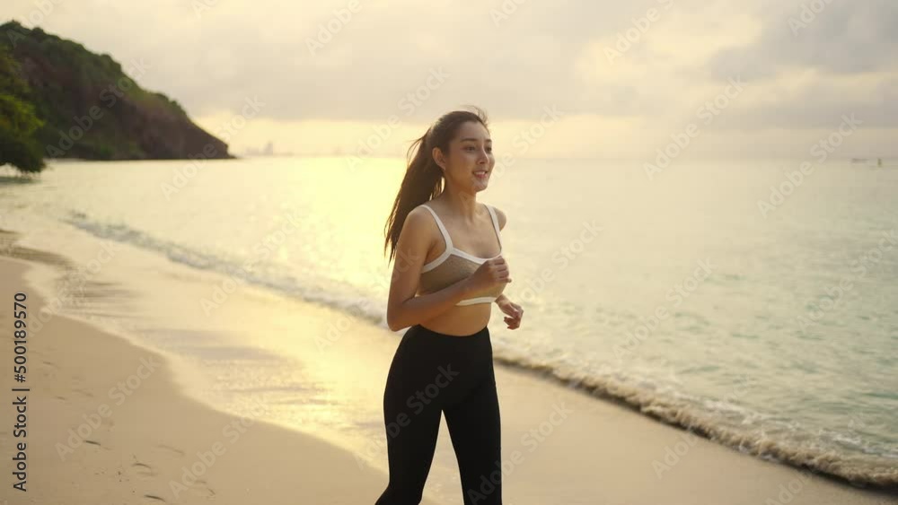 4K Confidence Asian woman in sportswear jogging exercise on tropical island beach in summer morning. Healthy female enjoy outdoor activity lifestyle sport training running workout on beach vacation 4K Confidence Asian woman in sportswear jogging exercise on tropical island beach in summer morning. Healthy female enjoy outdoor activity lifestyle sport training running workout on beach vacation
