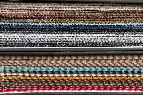 Catalog of different colors of fabrics for the client's choice for upholstery, examples of multi-colored fabrics as a background, fashion fabrics in the atelier